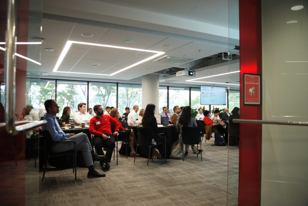 Researchers gather in a conference room to listen to research presentations Conference on Generative AI in Research Methods
