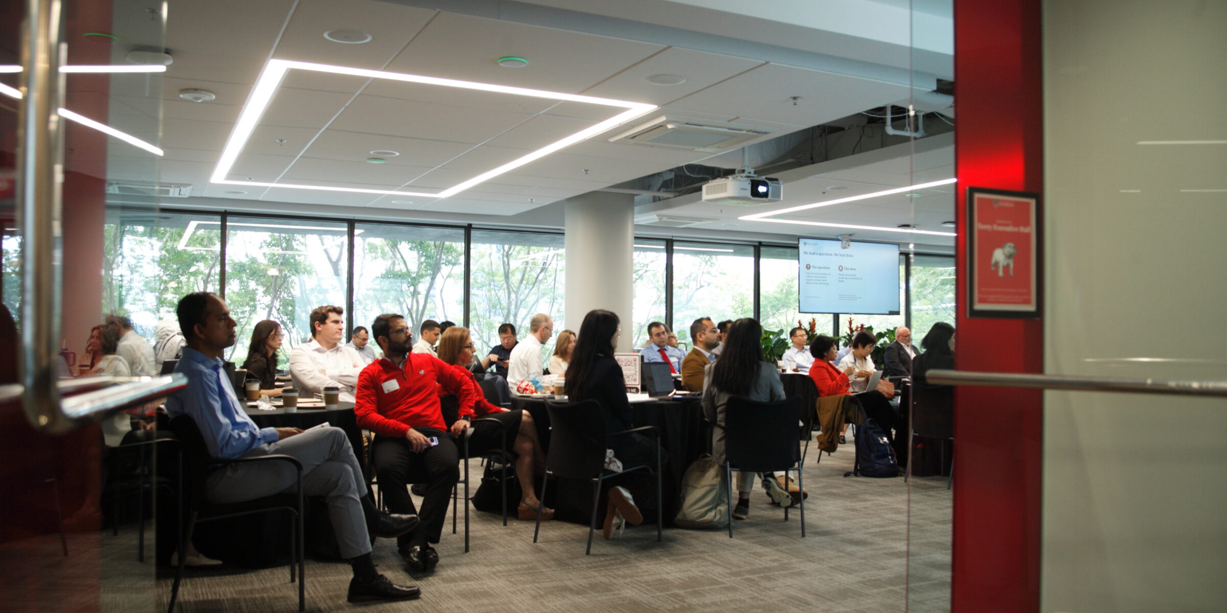 Researchers gather in a conference room to listen to research presentations Conference on Generative AI in Research Methods
