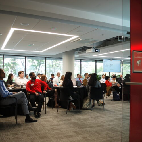 Researchers gather in a conference room to listen to research presentations Conference on Generative AI in Research Methods