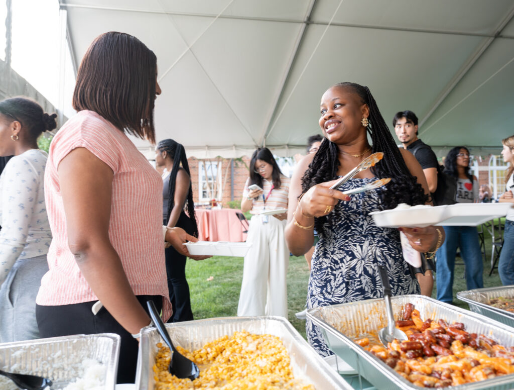 Terry College Welcome Back Block Party Students go down a buffet line of foods from different cultures at Terry College Welcome Back Block Party