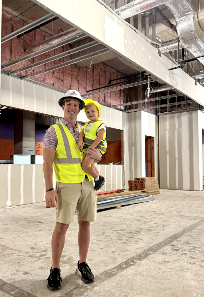 DallisandKiddoCropped Dallis Joiner holds his toddler son at the consstruction site