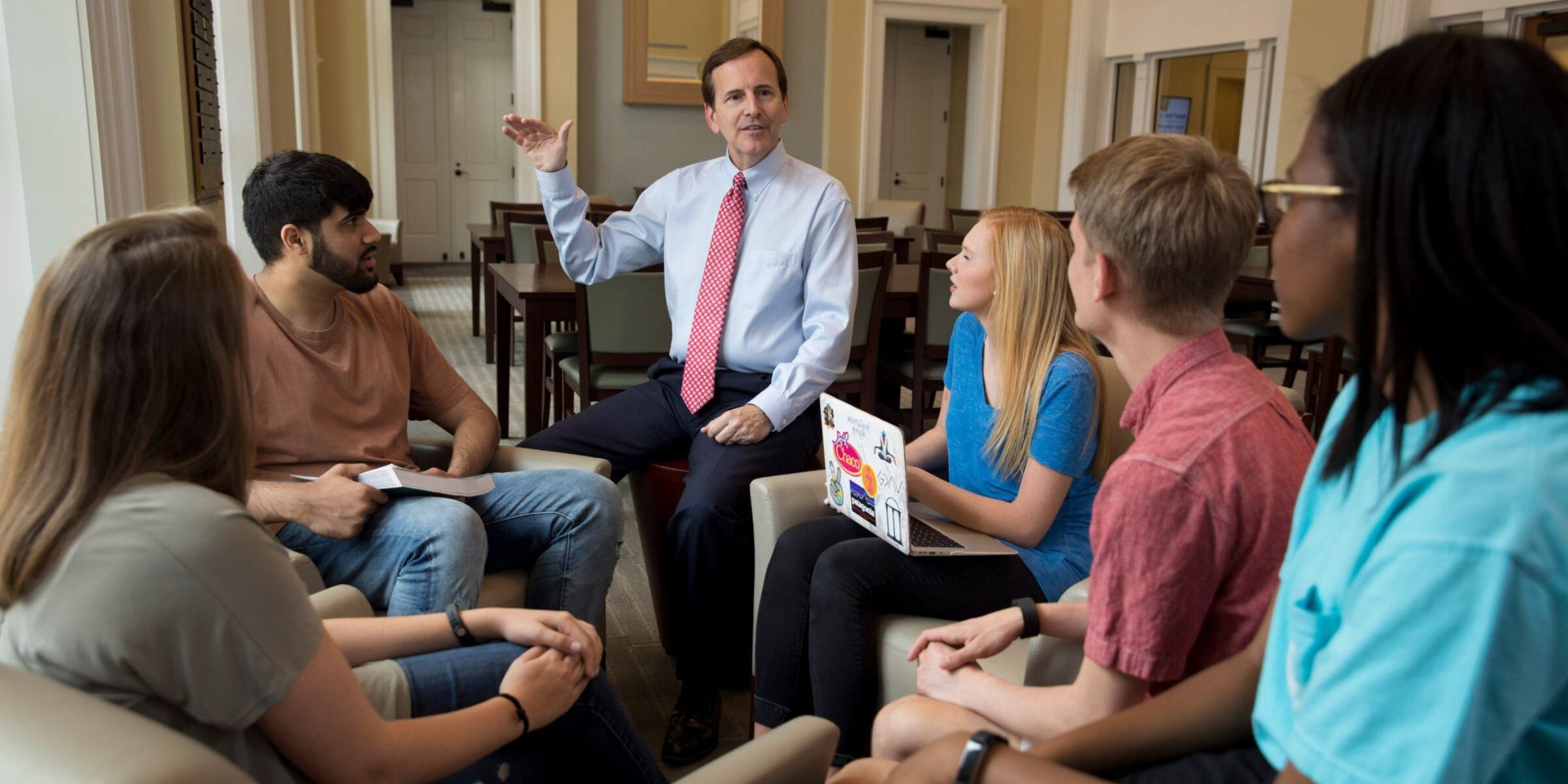 Professor speaking with a group of students