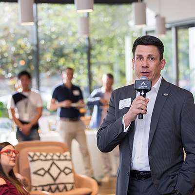 EMBA-impact Man holding a microphone