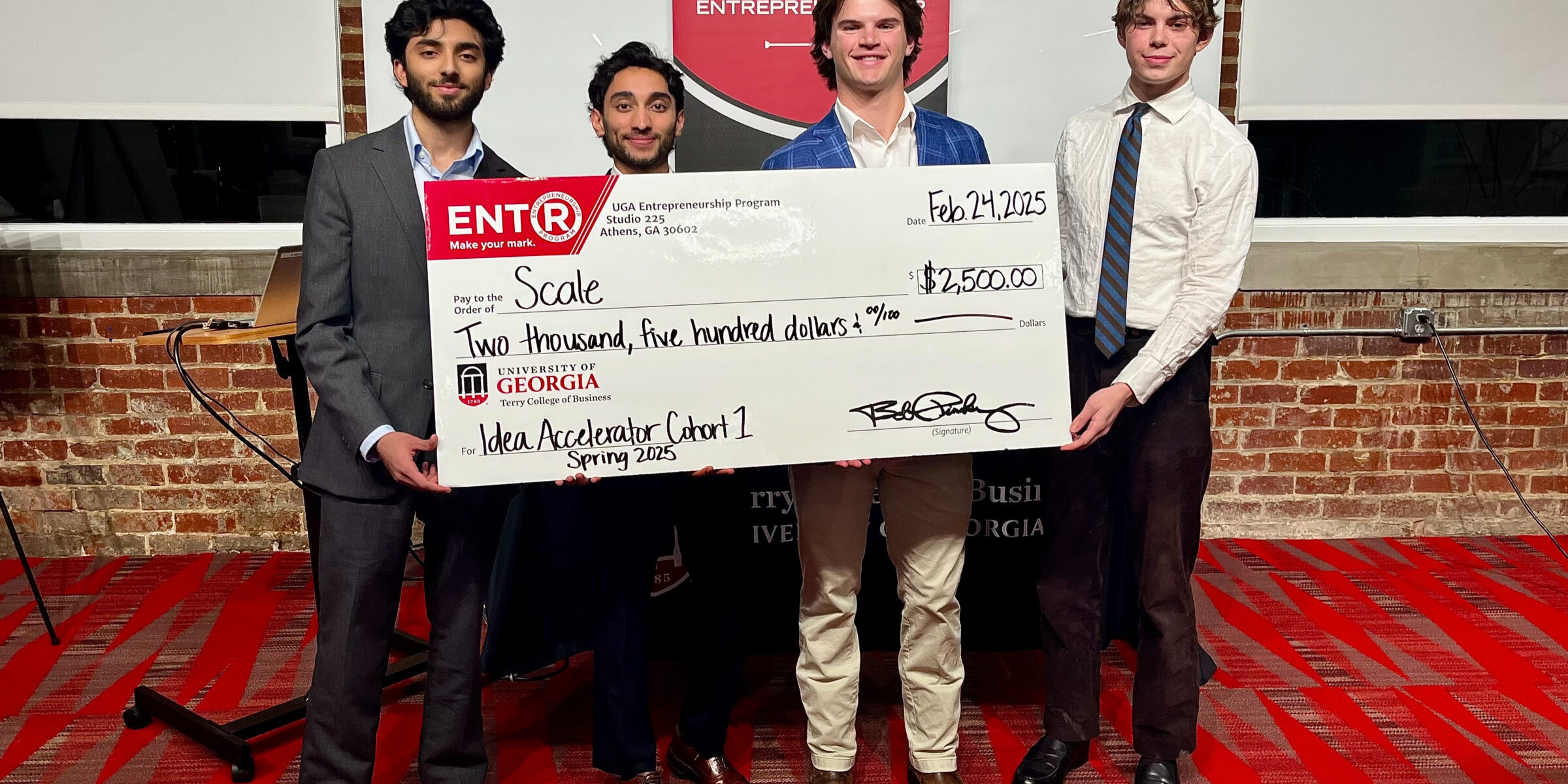 Winners of the Spring UGA Idea Accelerator Pitch Contest stand with a giant prize check.