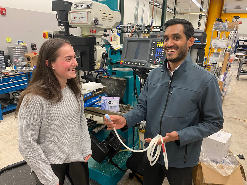 A product engineer at Jackson Medical shows Emily Mlyn a Glow Shield