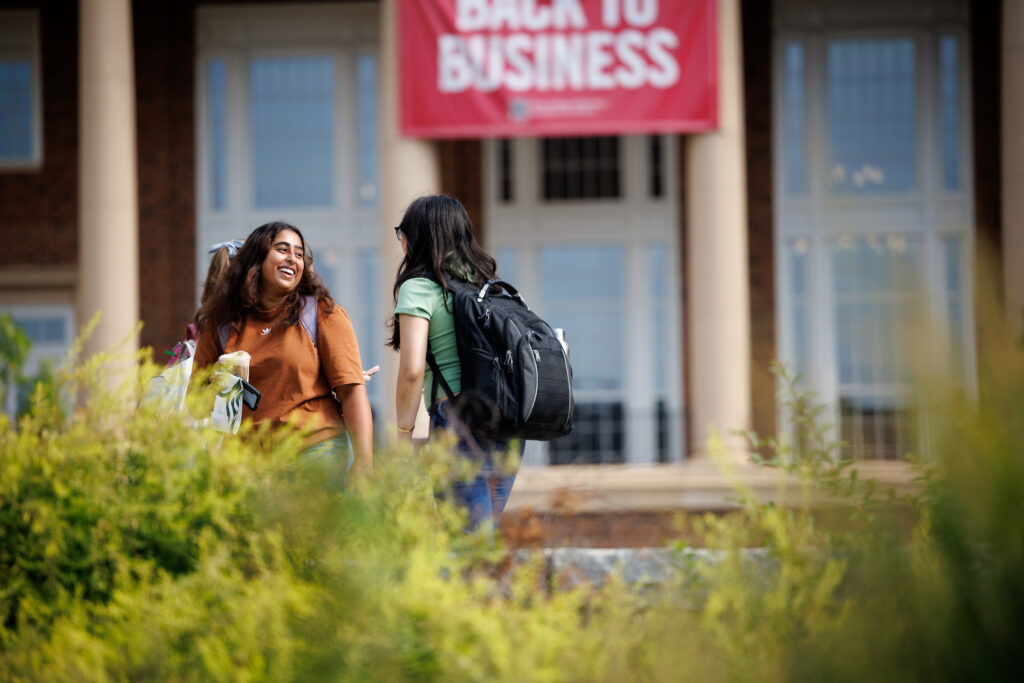 A UGA student stops to talk to her friend early on the first day of classes at the Terry College of Business Business Learning Community's Coca-Cola Plaza.