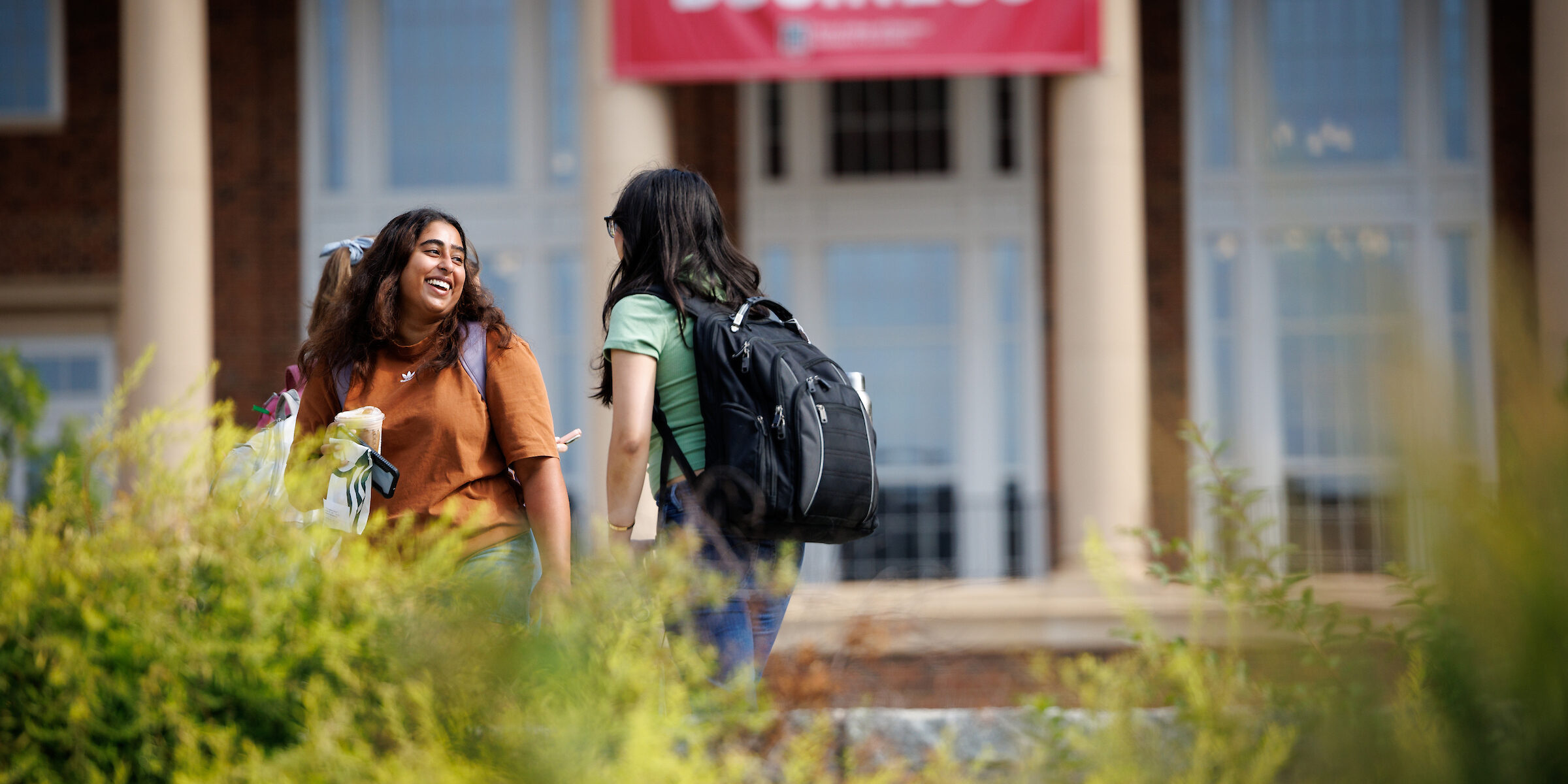 A UGA student stops to talk to her friend early on the first day of classes at the Terry College of Business Business Learning Community's Coca-Cola Plaza.