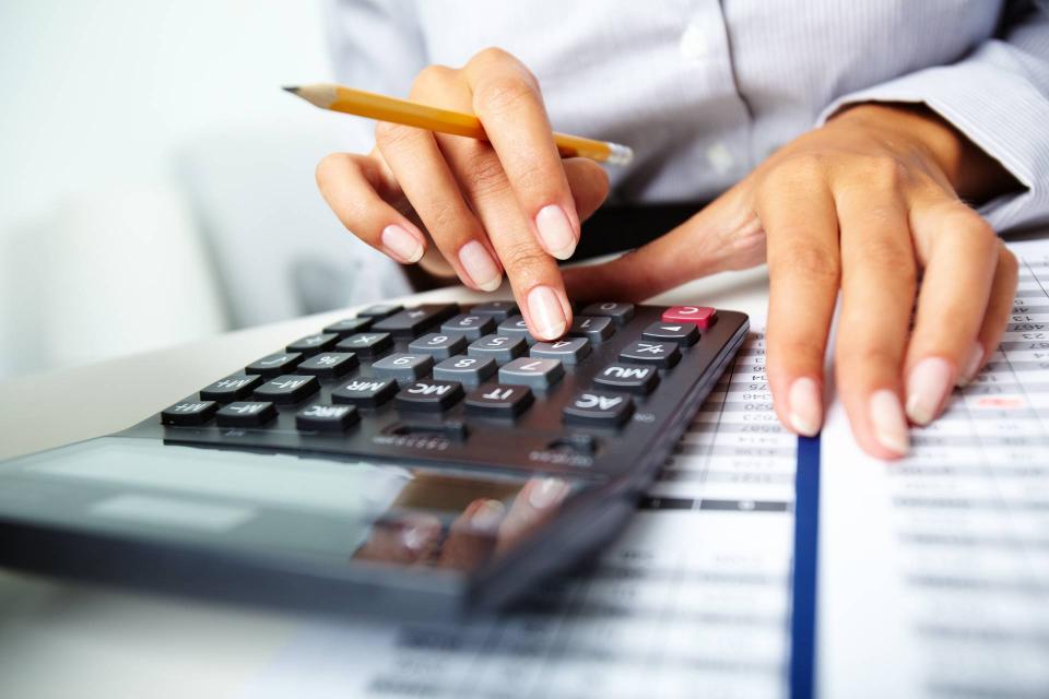 Stock image of hands typing in calculator