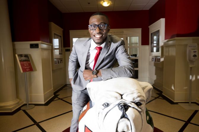 Ammishaddai Grand-Jean poses for a photo on a bulldog statue.