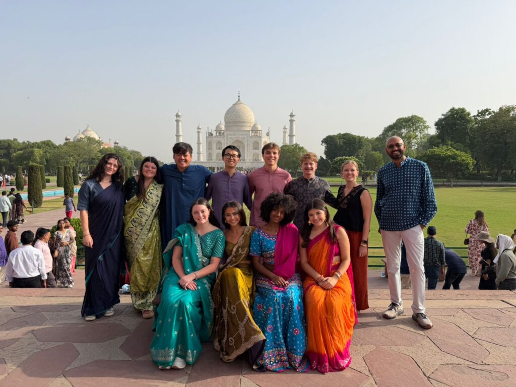 Terry students dressed in saris and kurta pajama in front of the Taj Mahal Study Abroad in India
