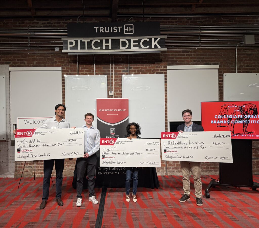 Aiden Silverstein, Nikhil Gandhi, founders of Cracked Up, Soran Mechale, of goTeff and John D. (J.D.) Thomerson, of Pet Health Innovations pose with novelty checks at the Truist Pitch Deck.