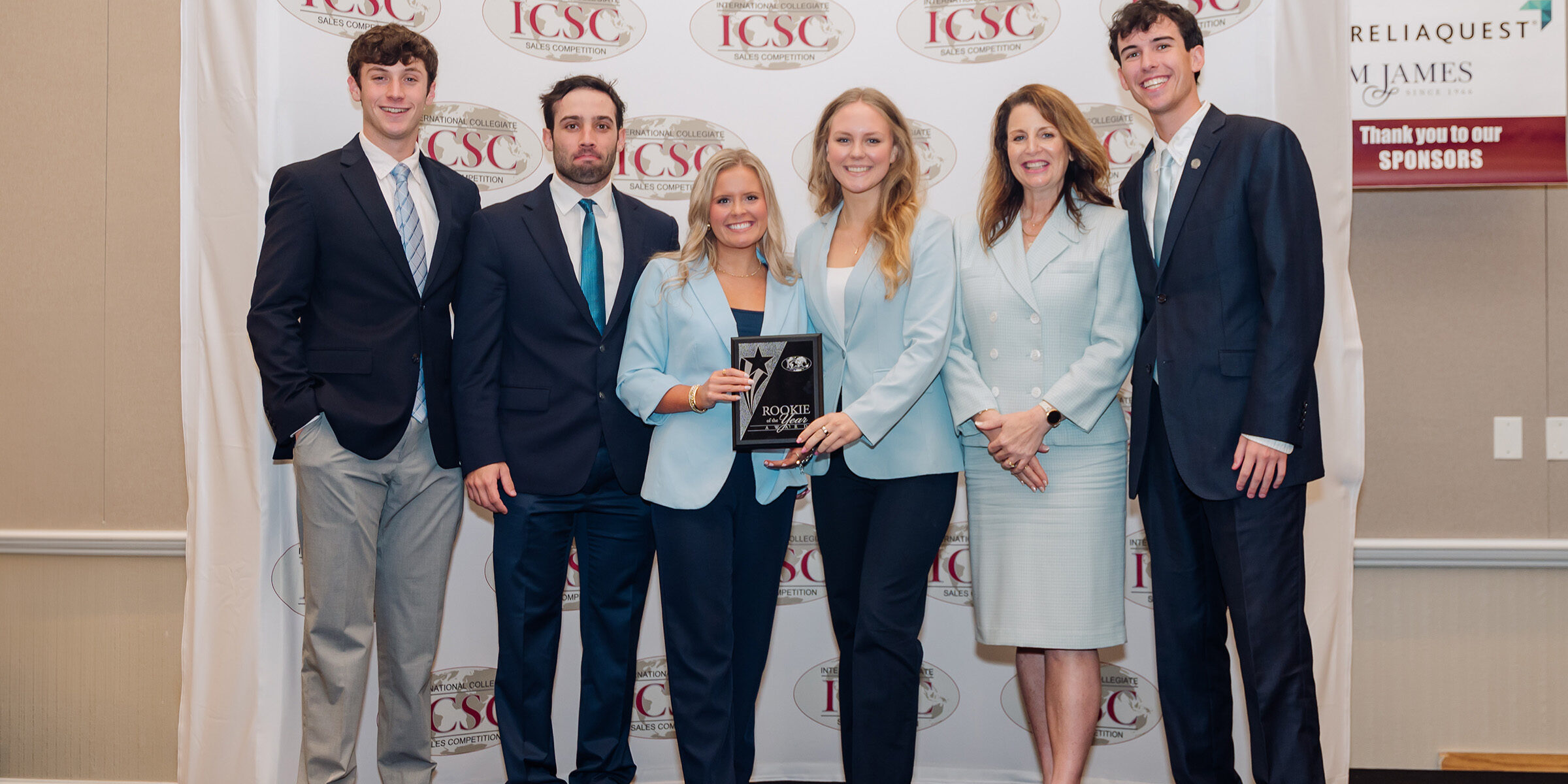 From left, Josh Krebs, Connor Johnson, Lauren Turner, Charlie Pansing, Cindy Rippe and Jordan Davis accept a rookie team of the year award at the International Collegiate Sales Competition.