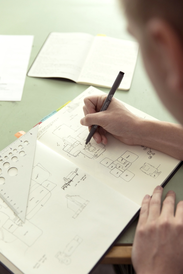 A detailed look at Jackson Mitchell's notebook used for drafting designs.