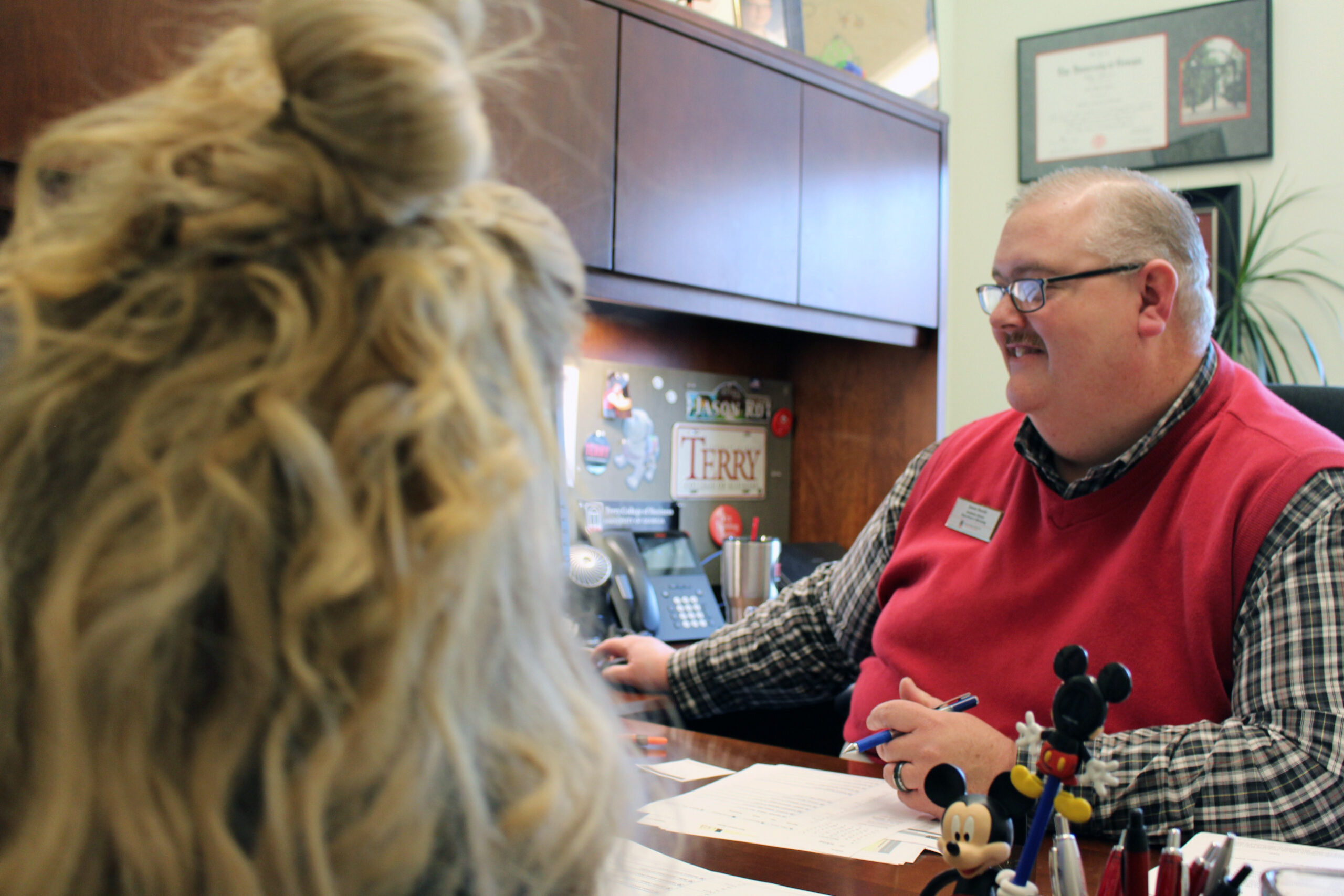 Academic Advisor Jason Booth meets with a student in his office.