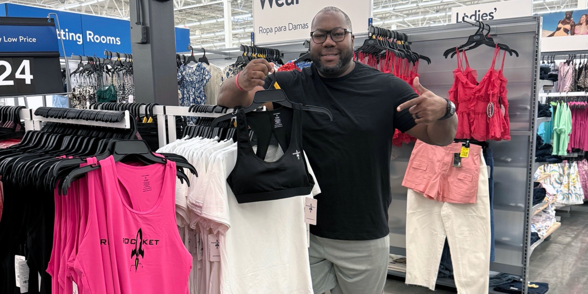 Jon Dabney with WalMart display of pink tank tops with the RocketSports-1 logo