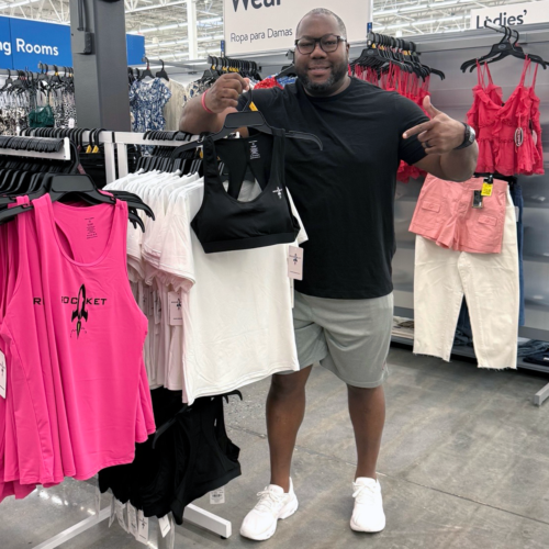 Jon Dabney with WalMart display of pink tank tops with the RocketSports-1 logo