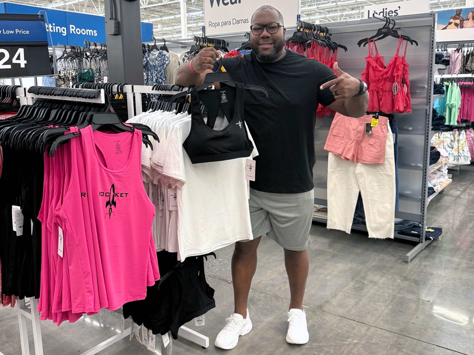Jon Dabney with WalMart display of pink tank tops with the RocketSports-1 logo