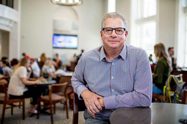 Terry College alumnus and former UGA football kicker poses for a photo in the Business Learning Community.