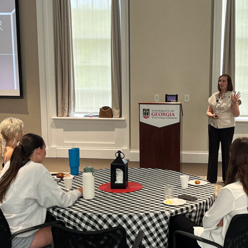 Kristen Taylor stands in front of a crowd of UGA students in the UGA Terry College of Business's Stelling Study.