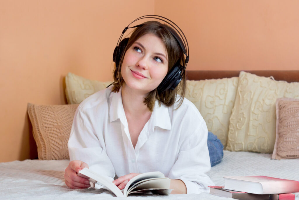 A young professional woman listens to a leadership podcast while relaxing