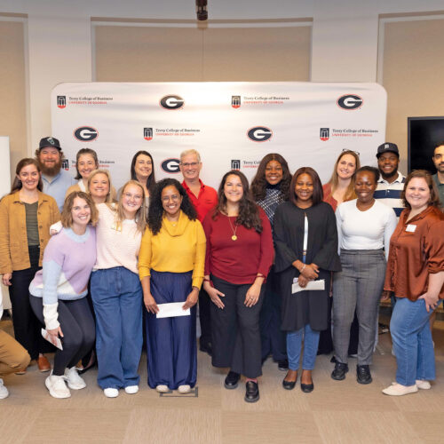 A group of MBA students and nonprofit leaders crowd into a group picture at the inaugural Georgia MBA Nonprofit Board Fellows Match Day.