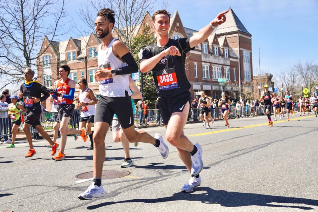 Jonathan Pelham (right) runs in the Boston Marathon to raise funds for Children First