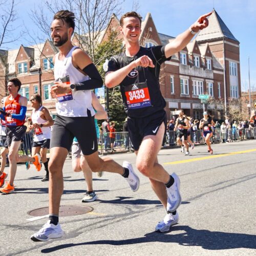 Jonathan Pelham (right) runs in the Boston Marathon to raise funds for Children First