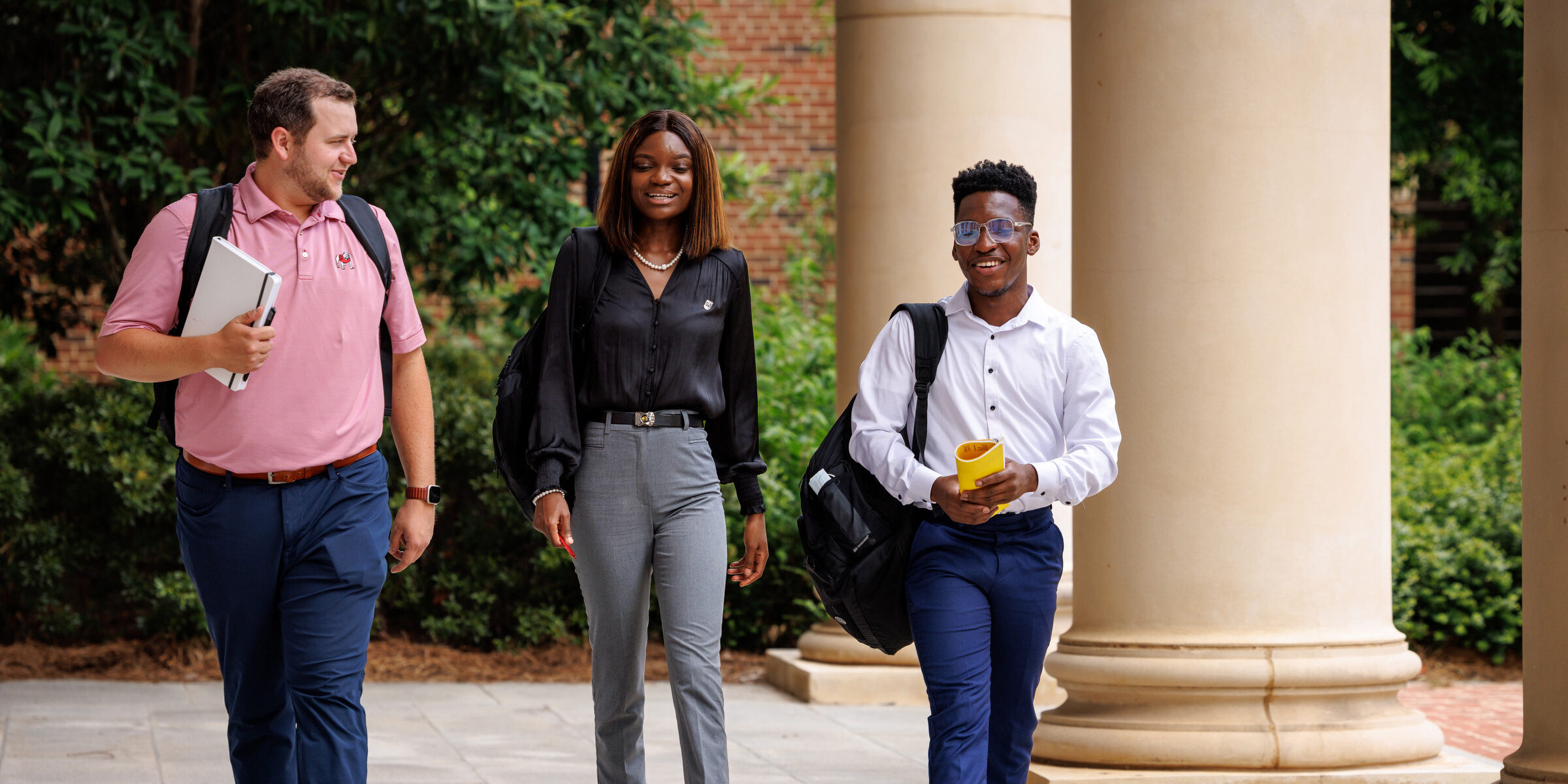 Three students walk together.