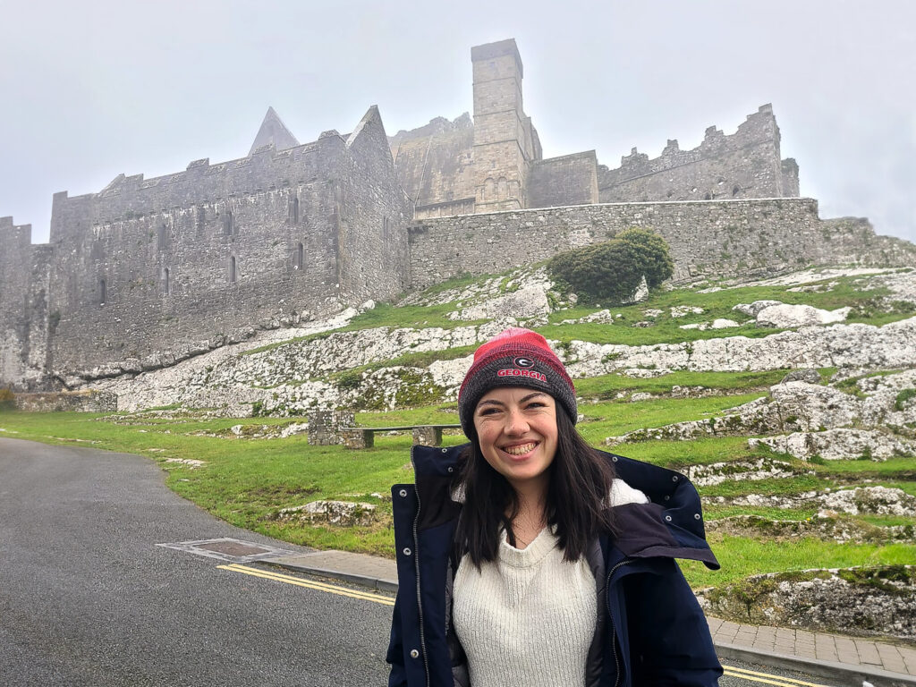 Maeve Breathnach in front of Rock of Cashel castle n Ireland.