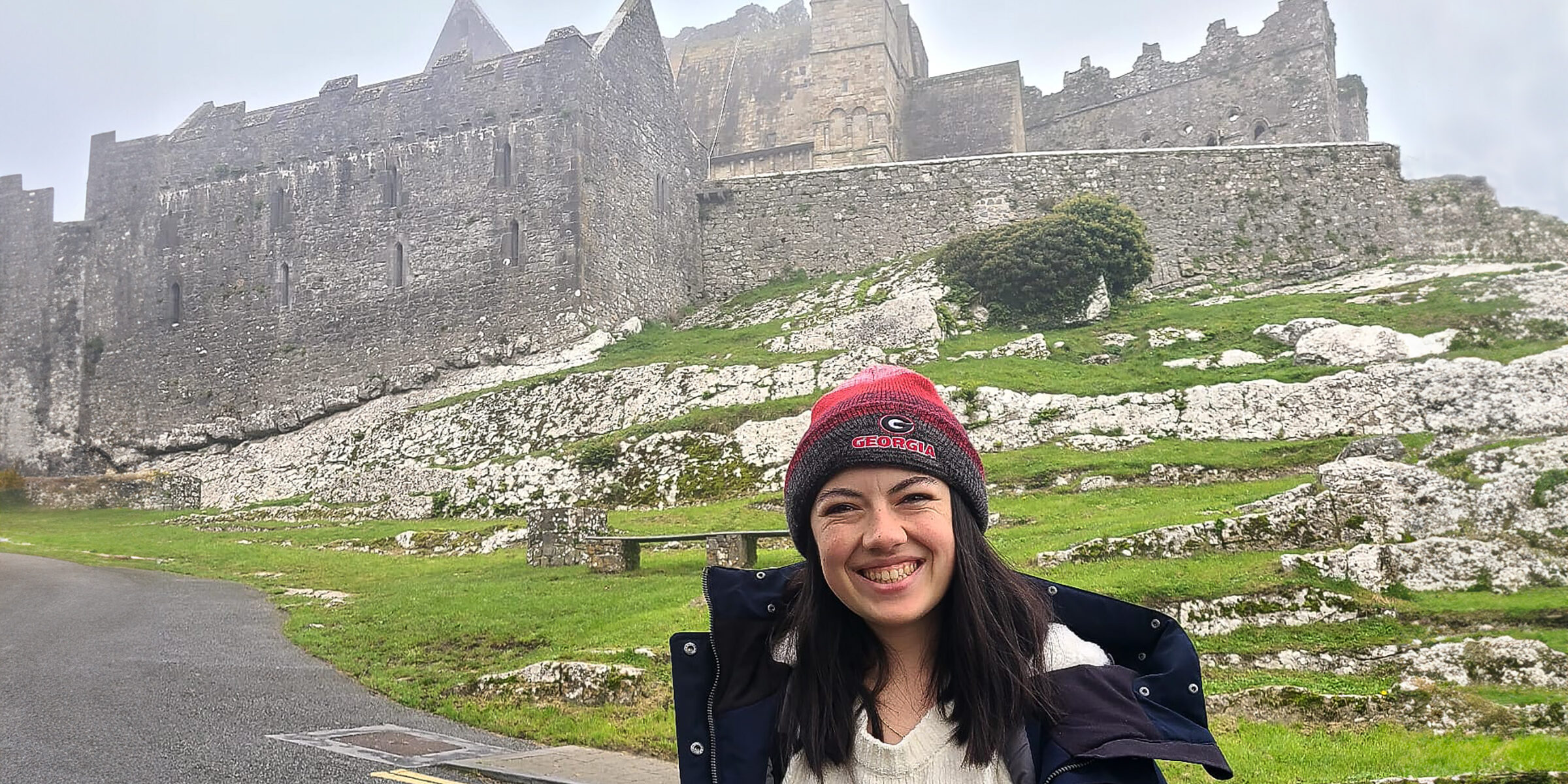 Maeve Breathnach in front of Rock of Cashel castle n Ireland.