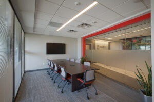 Meeting room with long table and mounted TV
