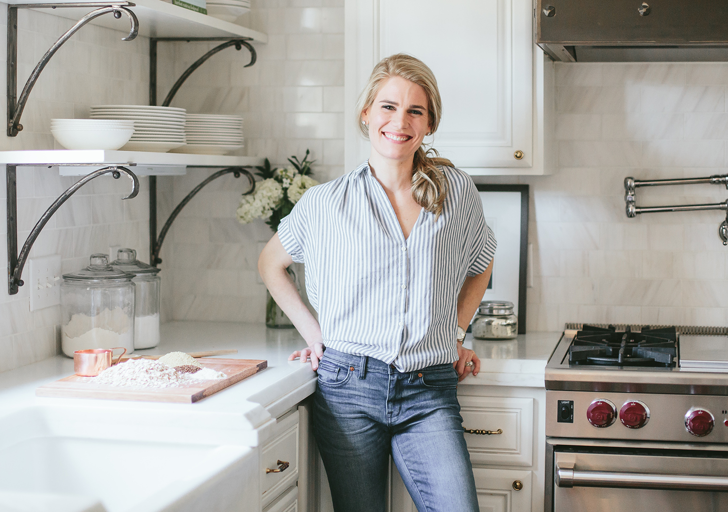 Dina Carey poses for a photo in a kitchen.