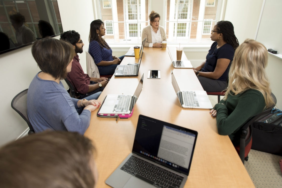 Marie Mitchell meets with doctoral students in one of the team rooms inside Amos Hall. 