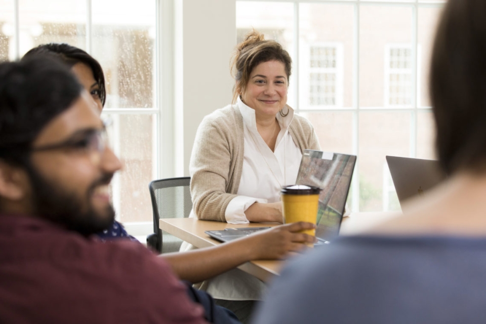 Marie Mitchell listens to a doctoral student during a meeting in one of the team rooms inside Amos Hall.