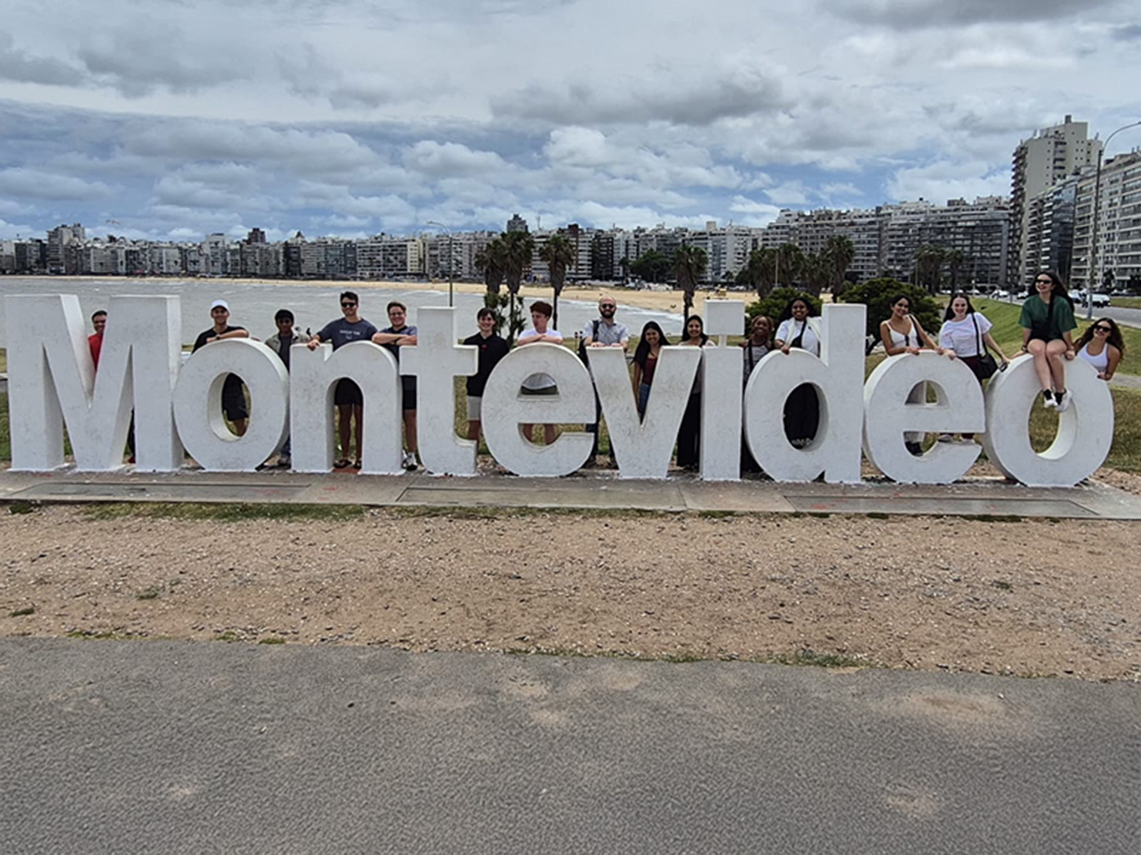 Students pose with the Montevideo sign in the capital of Uruguay during a winter study away trip.