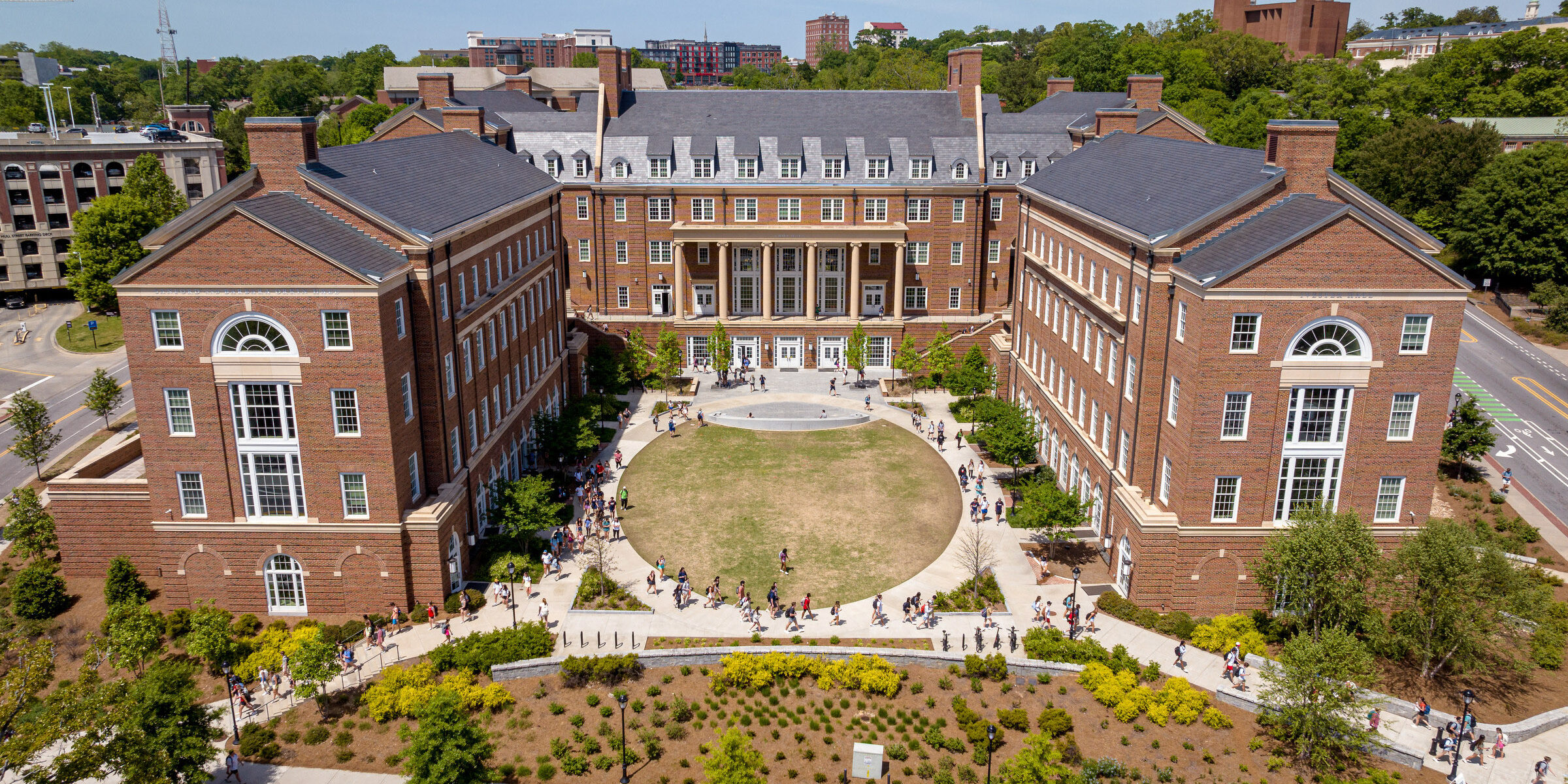 Students walk outside the Business Learning Community.