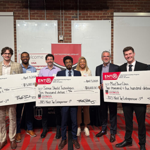 Winners of the Next Top Entrepreneurship Program pose with novelty checks