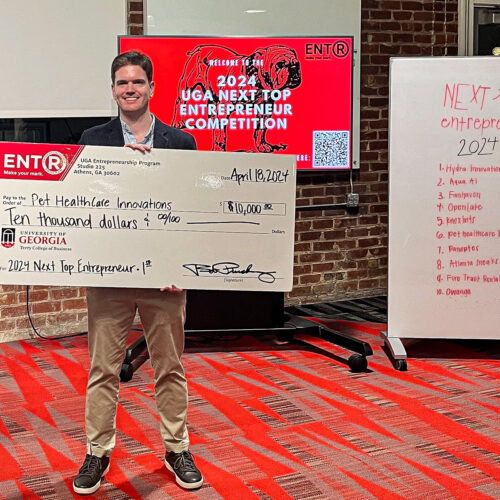 J.D. Thomerson stands with giant novelty check at Studio 225.