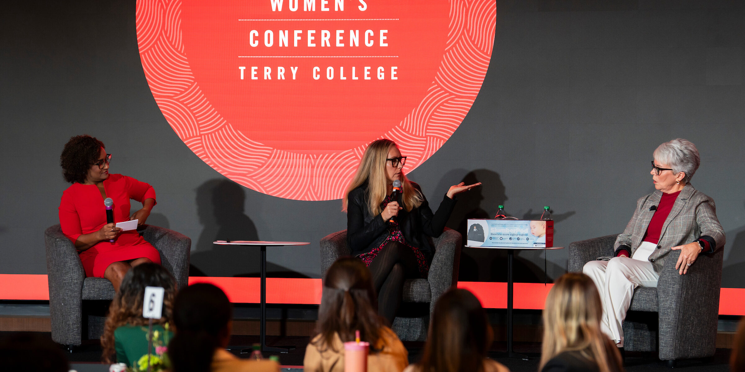 MC Lori Wilson speaks with mother and daughter entrepreneurs Katy Mallory and Lou Childs on stage at the Terry College Professional Women's Conference.