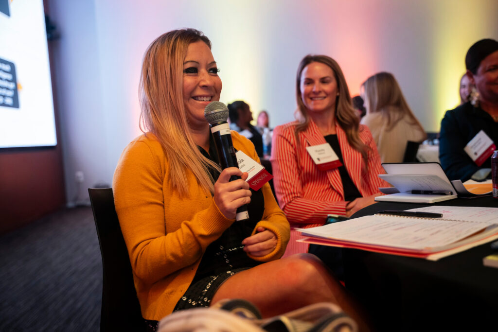 at the Terry College Professional Women's Conference uses a microphone to ask a question. 
