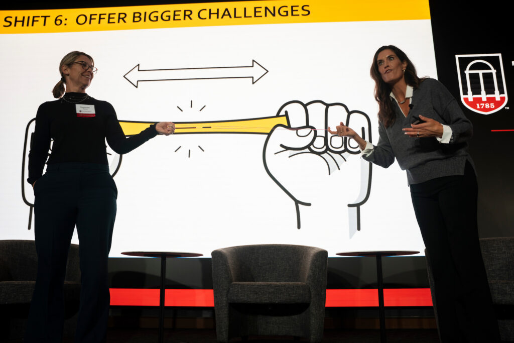 Leadership speaker Allysa Gallagher uses a rubber band to illustrate the importance of helping employees stretch themselves at the Terry College Professional Women's Conference.