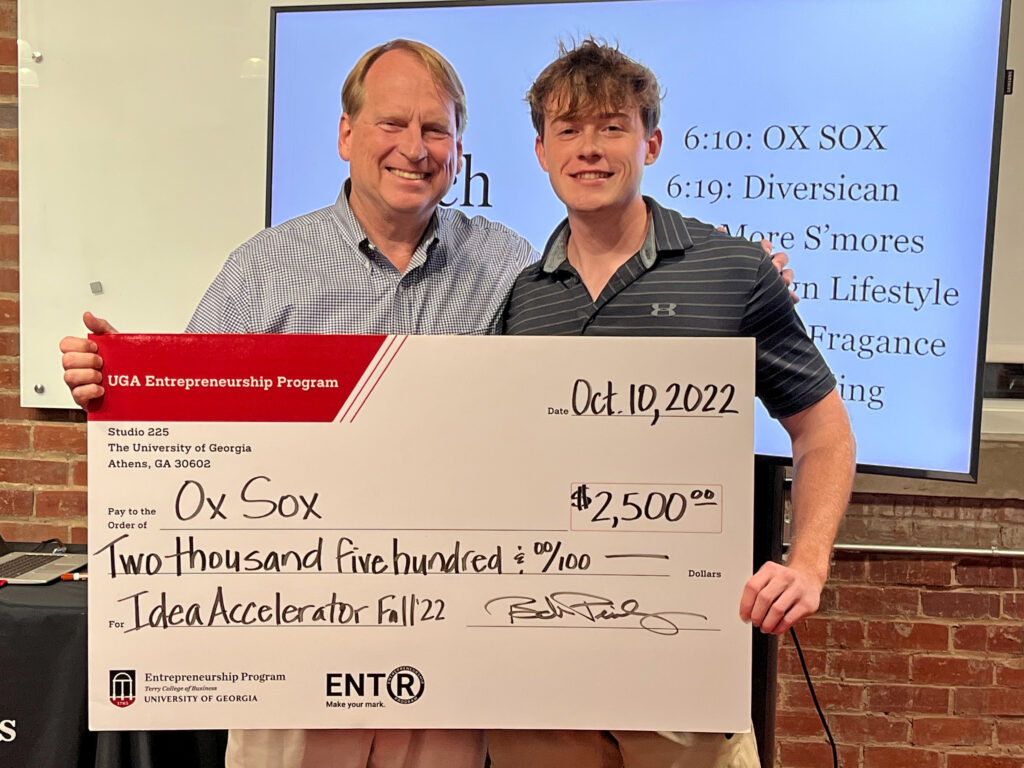 Bob Pinckney and Matt Tesvich holding a novelty prize check