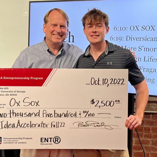 Bob Pinckney and Matt Tesvich holding a novelty prize check