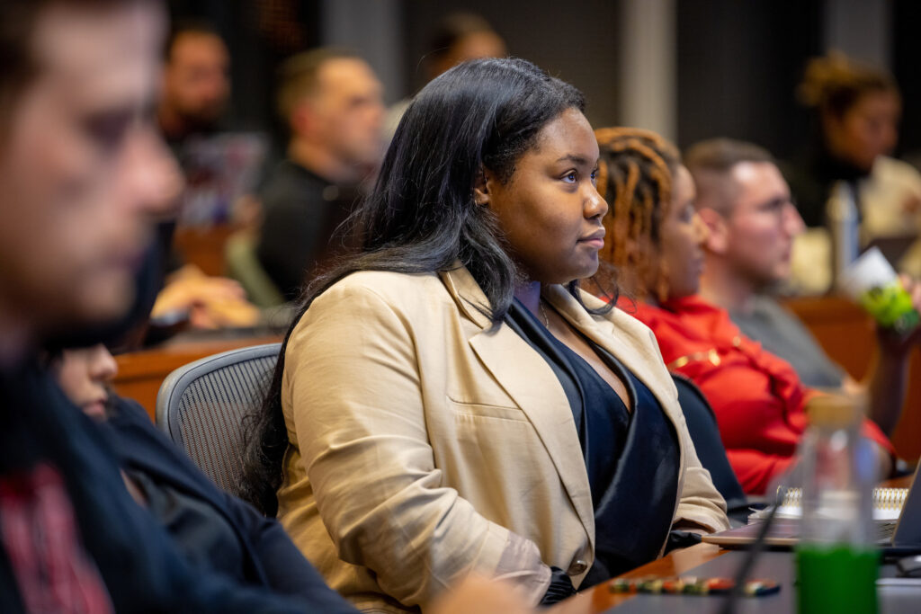 A young-adult African Professional MBA student listens intently to a lecture in class.