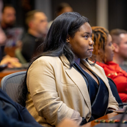 A young-adult African Professional MBA student listens intently to a lecture in class.