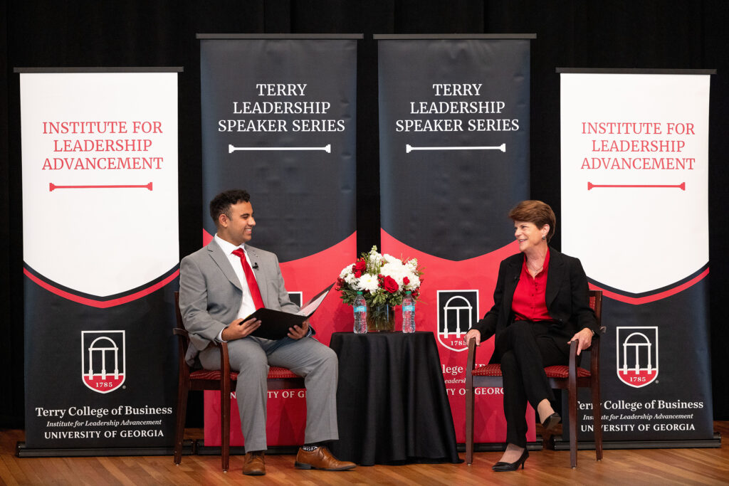 A student speaks with Pam Rogers on stage at the UGA Chapel.