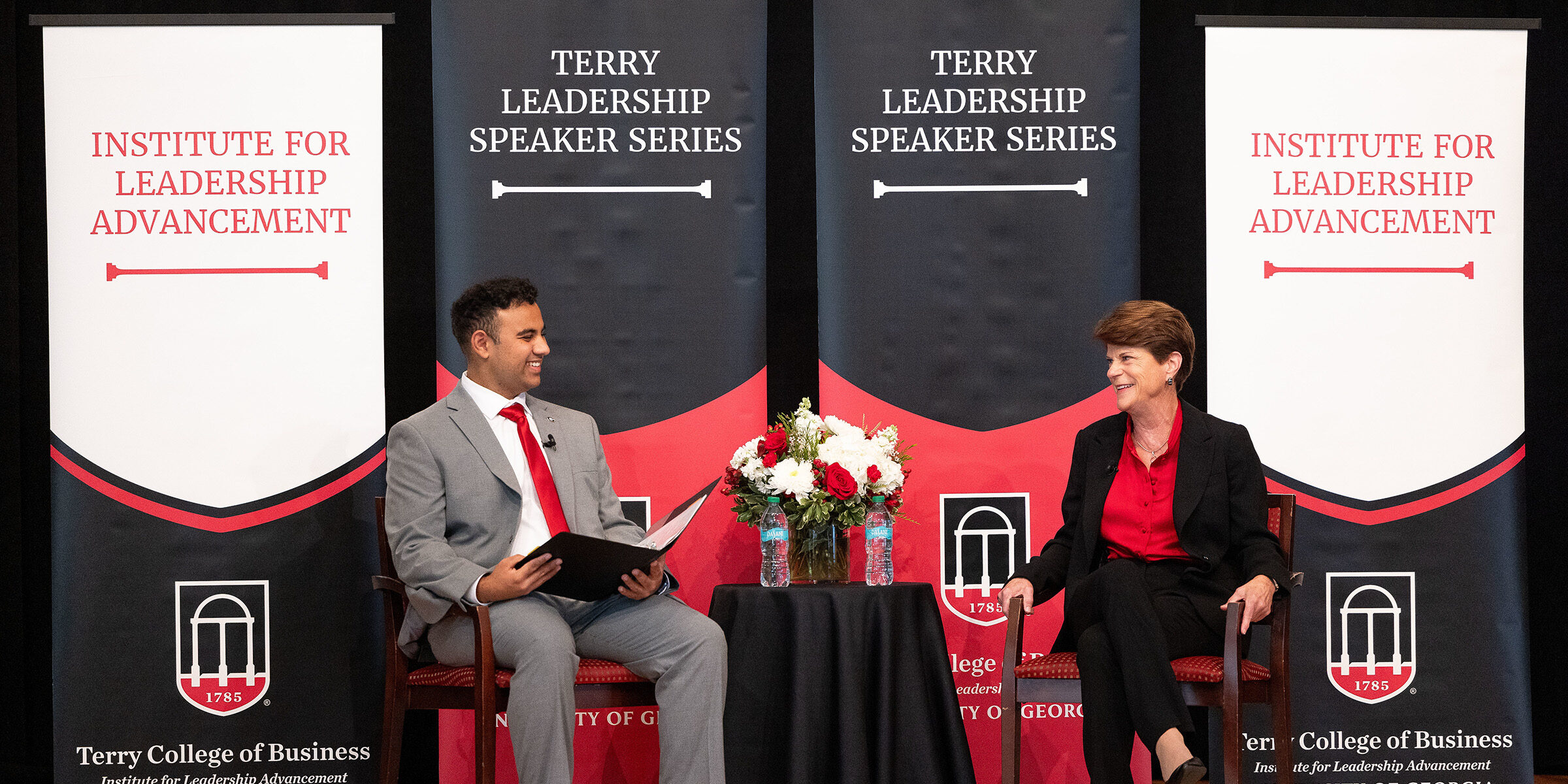 A student speaks with Pam Rogers on stage at the UGA Chapel.