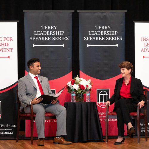 A student speaks with Pam Rogers on stage at the UGA Chapel.