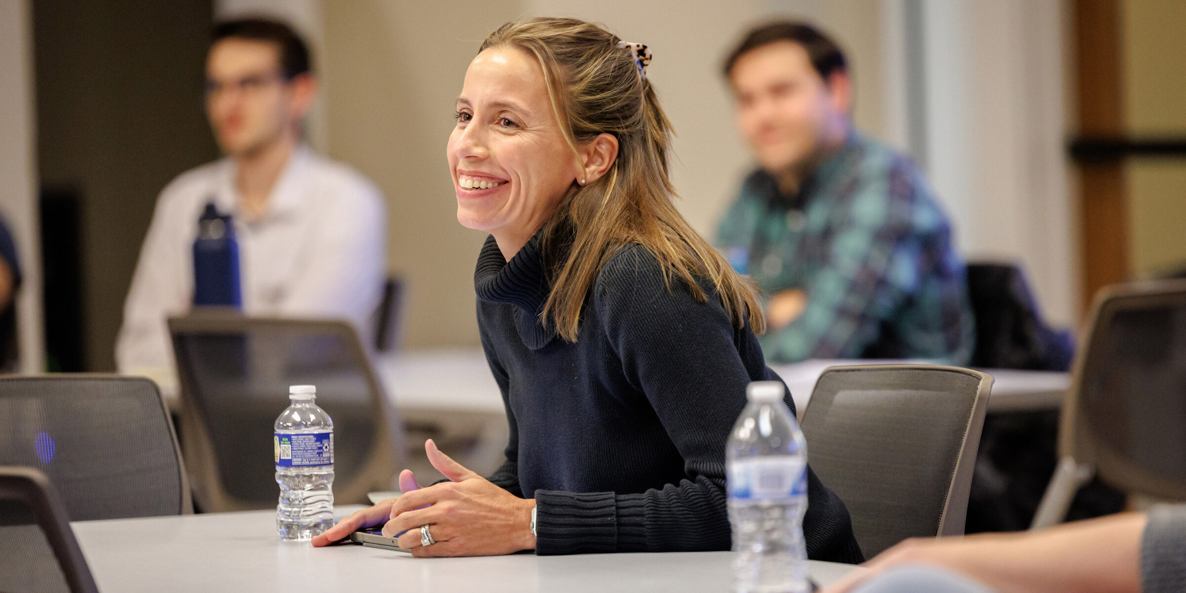 Woman sitting at desk smiling