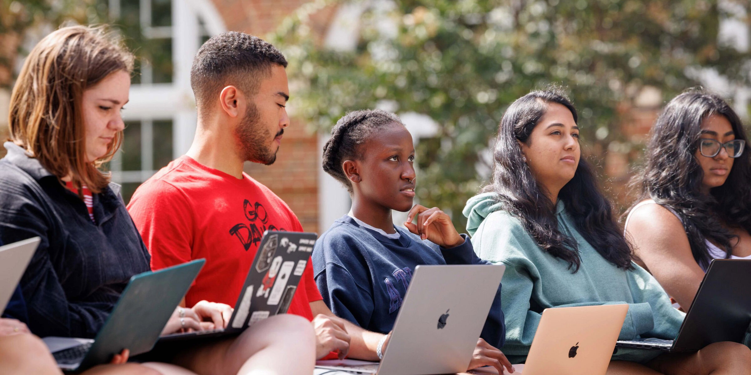 Students attend class outdoors.